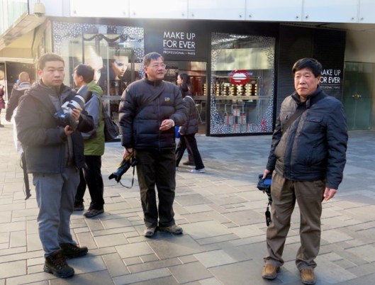 Hanging together rain or shine, they wait for the scene to happen