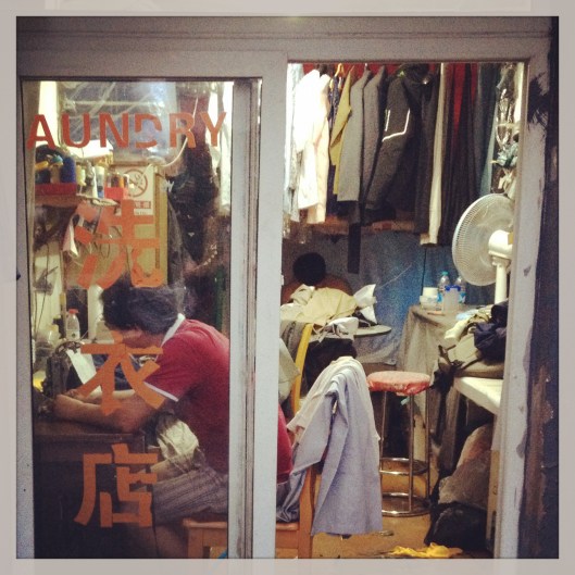 A tailor still hovering over his sewing machine at 11pm